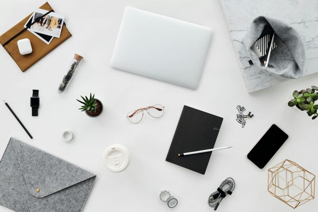 Aesthetic top-down view of office essentials on a clean white surface, perfect for creative inspiration.
